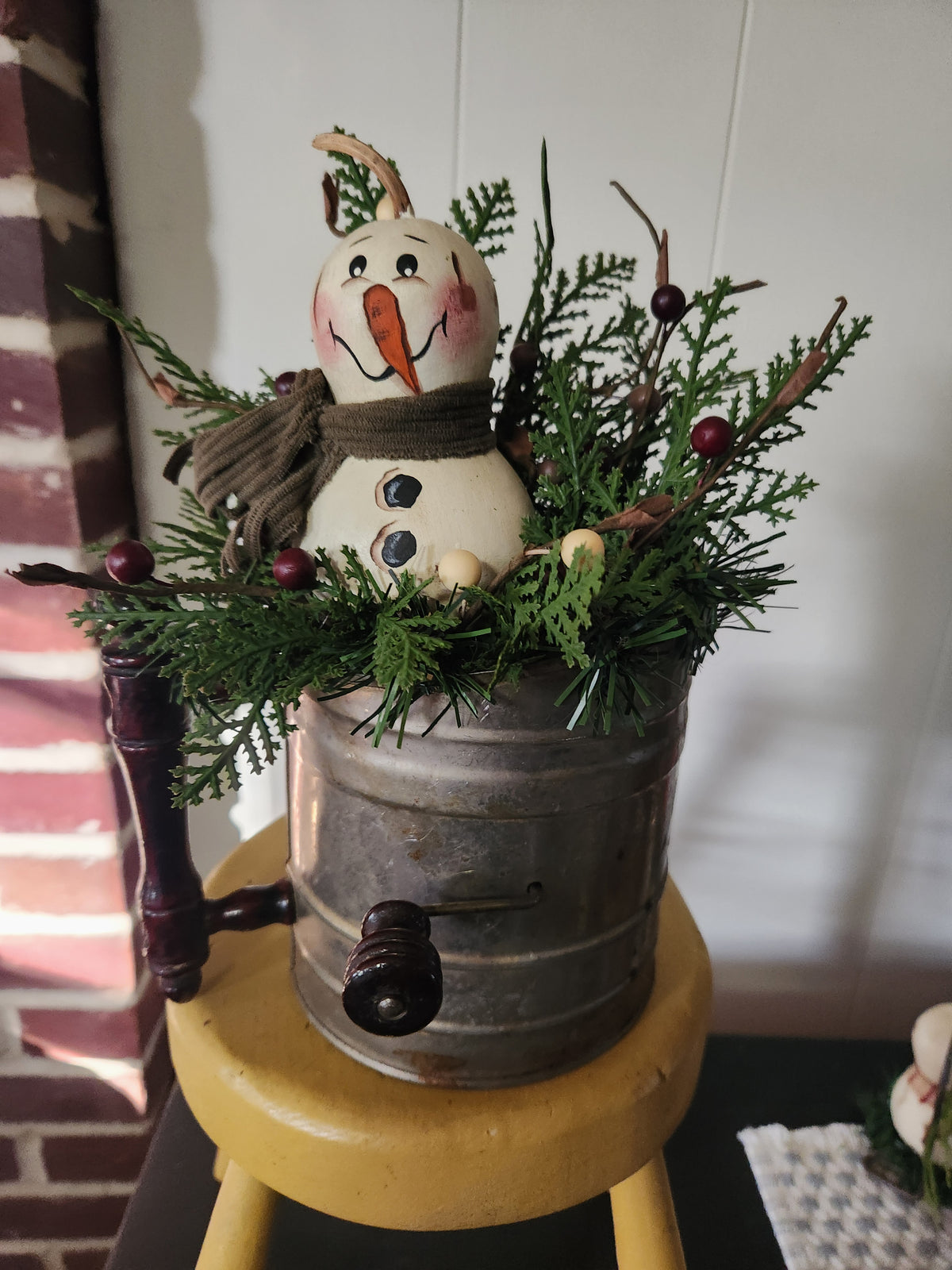 Snowman gourd arrangement in vintage sifter