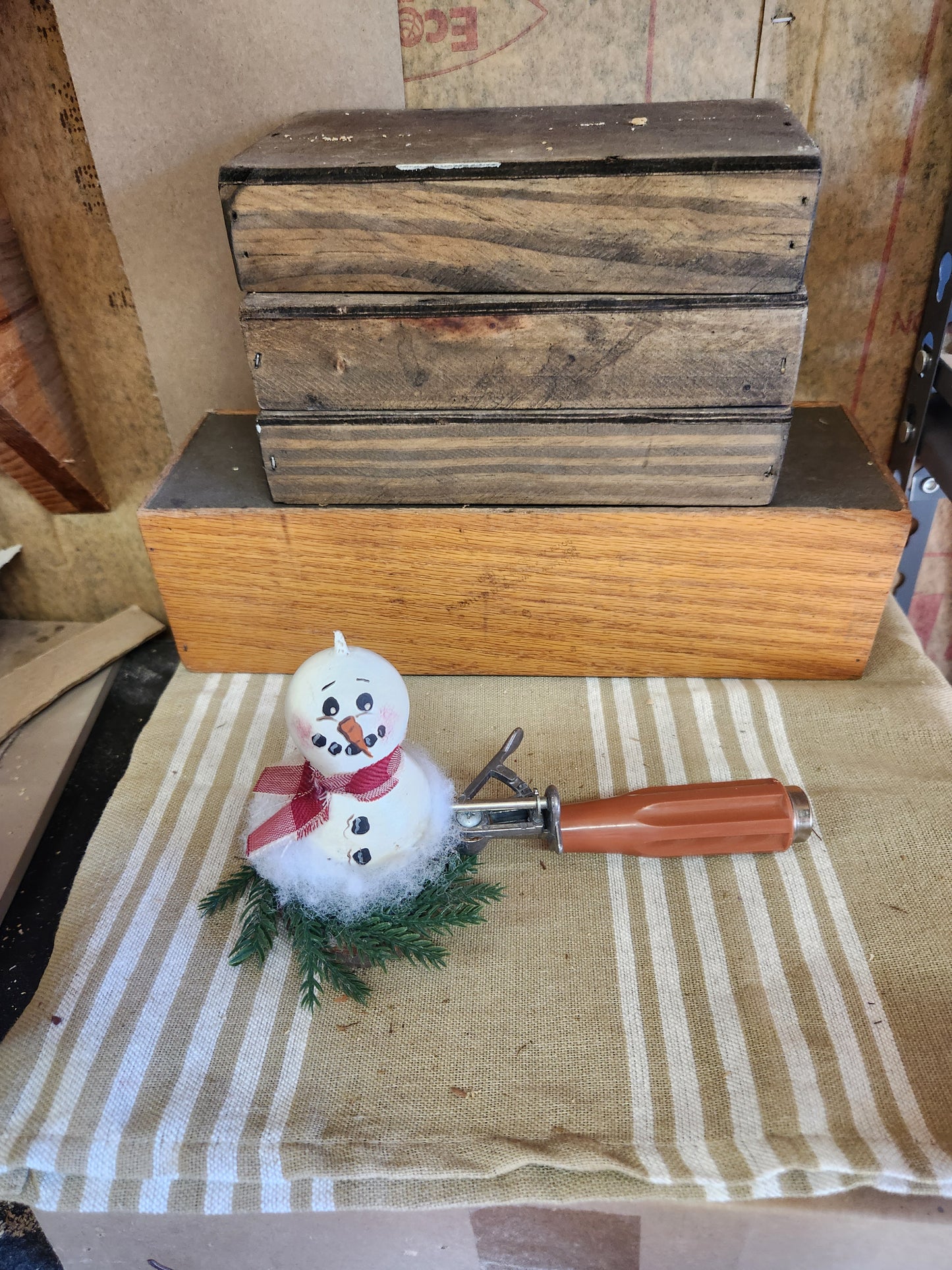 Snowman gourd in ice cream scoop with greenery