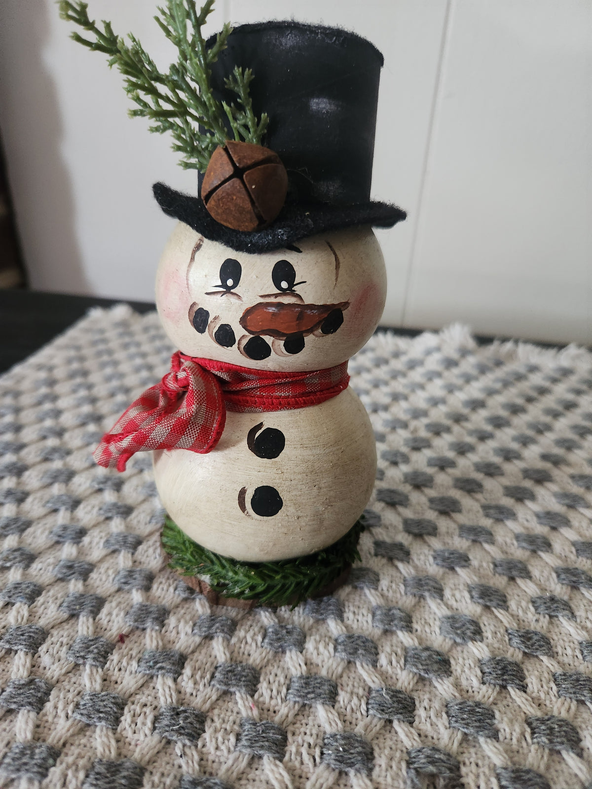 Snowman gourd with greenery around bottom