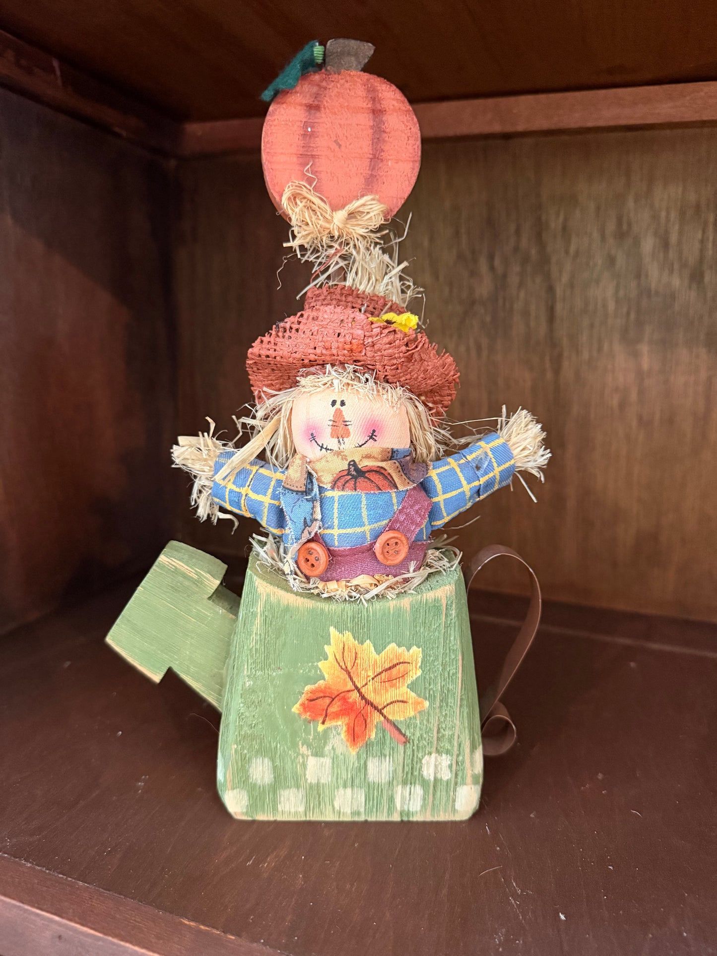Scarecrows in wood watering can