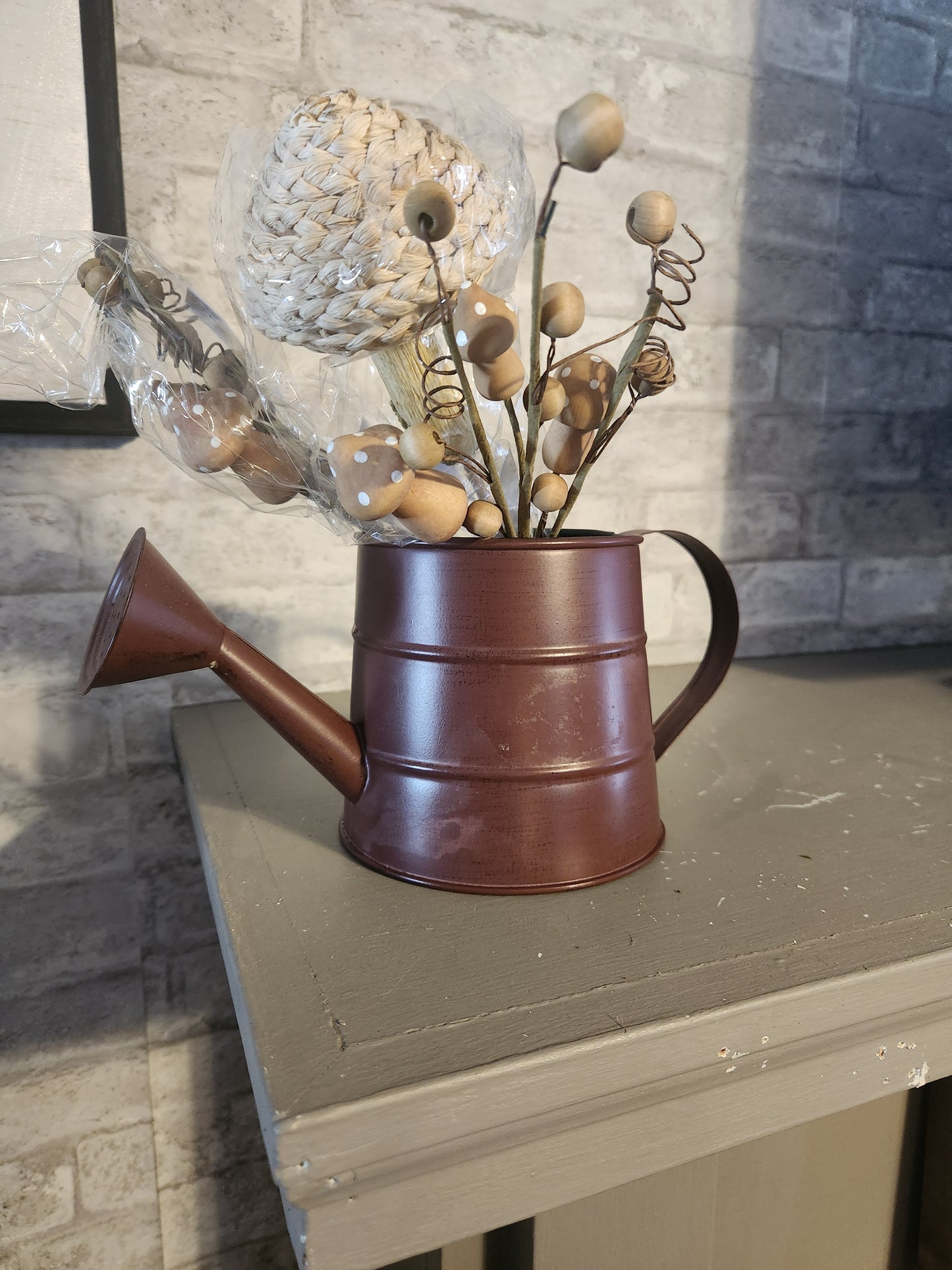 Watering can with mushroom picks