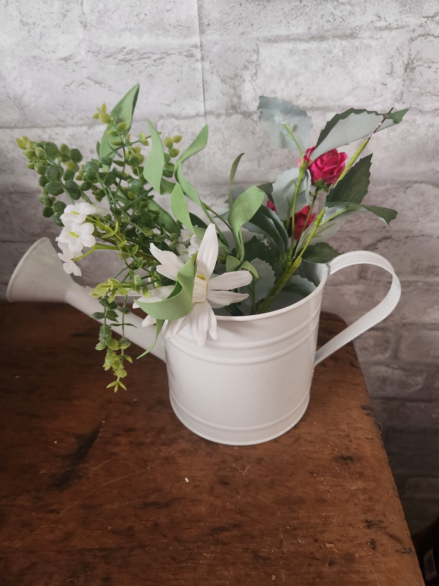 Watering can with flowers
