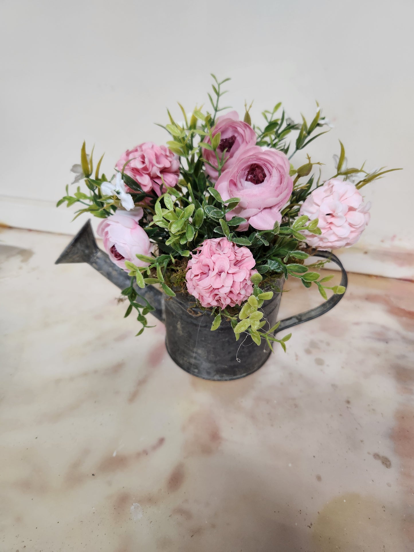 Watering can with pink flowers