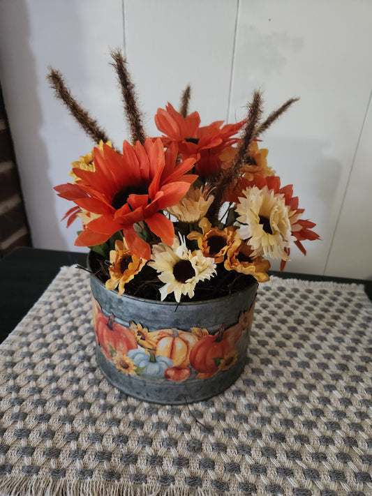 Arrangement with pumpkins on the outside of container