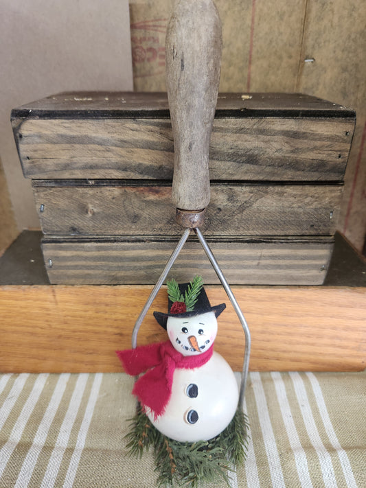 Gourd in vintage potato masher