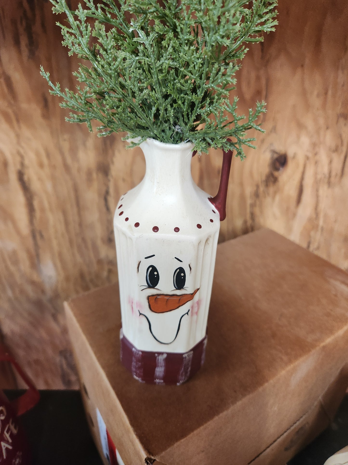 Snowman pitcher with greenery
